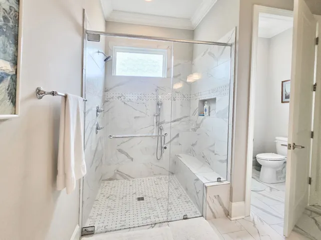 Primary Zero Entry tiled shower w/bench & private water closet