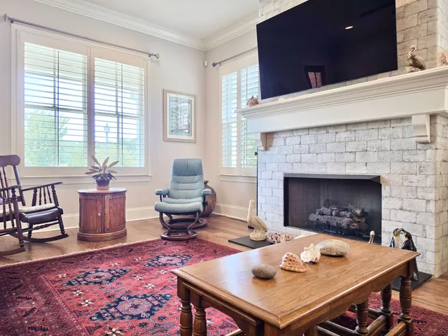 Great Room w/gas log fireplace, Crown Moulding, & Plantation Shutters