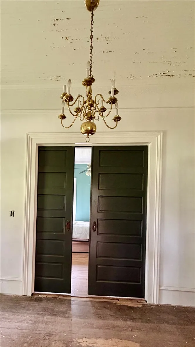 There are working double pocket doors into the left front bedroom.