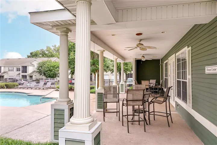 A welcoming poolside retreat with a covered patio, perfect for relaxation and socializing.