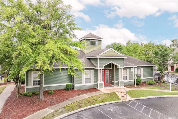 A well-maintained community building with ample parking invites residents inside.