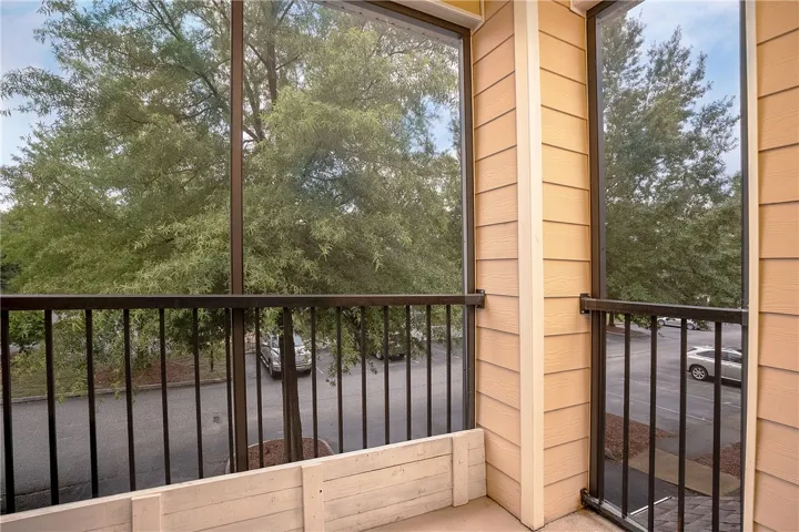 A private balcony offers serene tree-lined views, perfect for peaceful mornings.