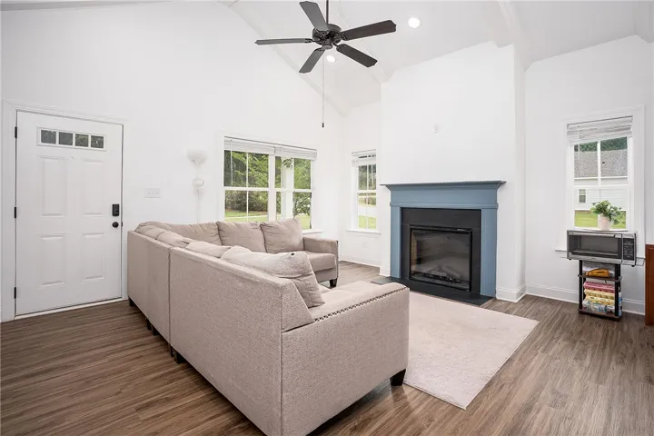 A welcoming living area showcases a cozy fireplace and high ceilings.
