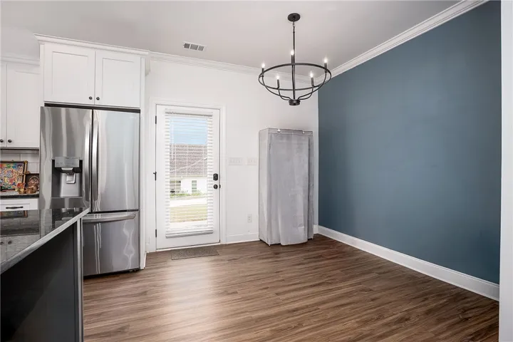 Laminate flooring flows throughout this eat-in kitchen.