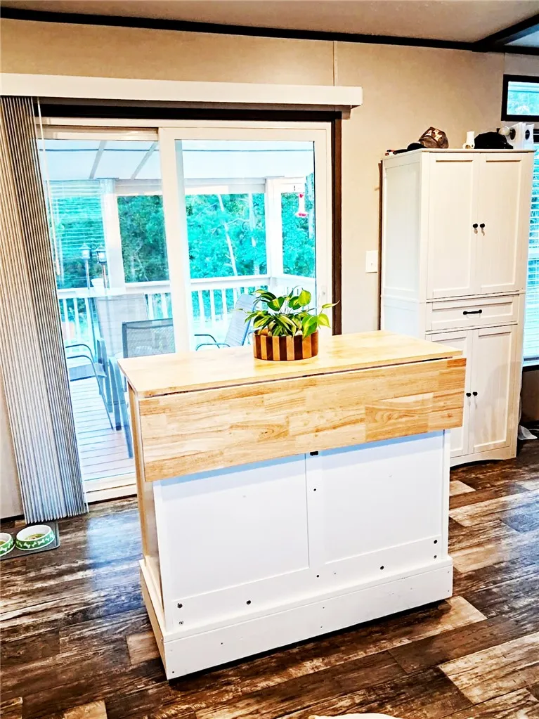 Sliding glass doors open from the dining area directly onto a covered back deck. This floating island can serve as storage and eating with adjustable side.