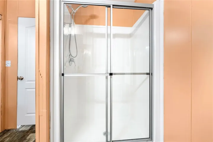 Glass shower enclosure provides a clean and functional bathing area.