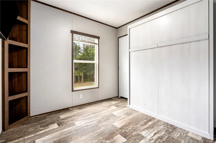 Picture of same room with Murphy Bed folded up.  Allows for more room.