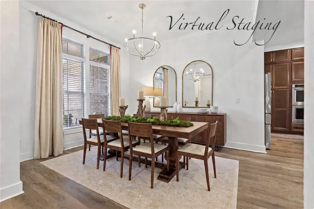 Elegant flooring, custom drapes, and a gorgeous chandelier enhance this dining space, ready for memorable meals and entertaining.