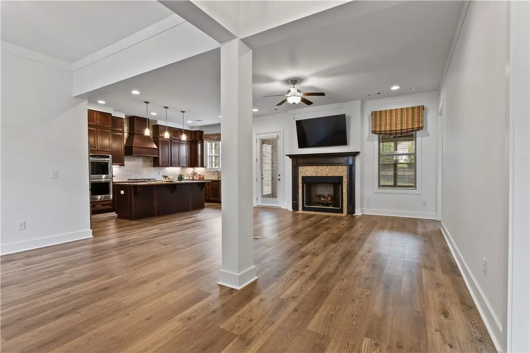 An open-concept interior offers a fireplace, LVP wood floors, and recessed lighting in a flowing layout.