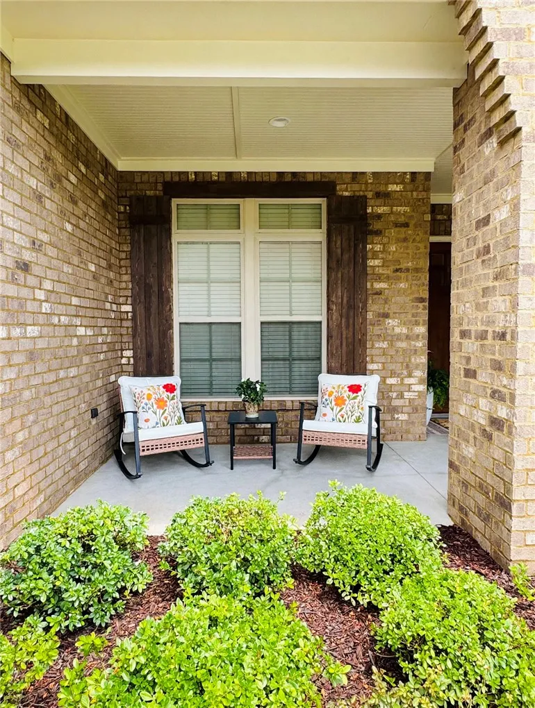 Beautiful covered porch perfect for enjoying the outdoors while reading, having coffee, and seeing your neighbors. It's so quiet you might fall asleep!