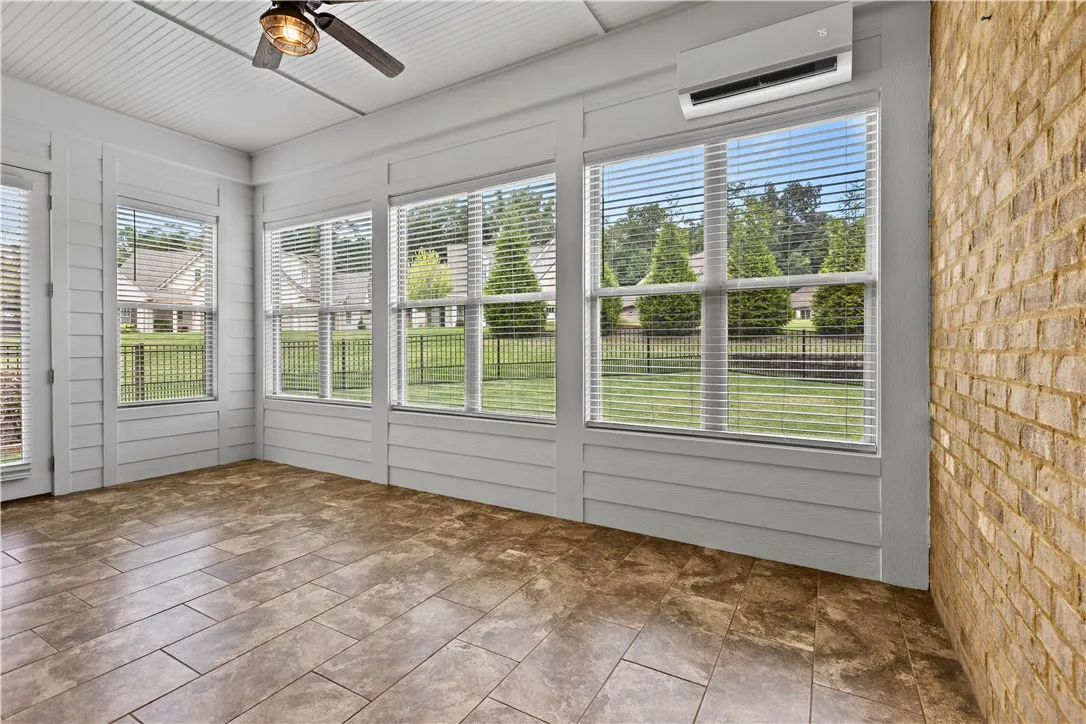 Spacious sunroom offers a lot of light! With open windows enjoy a sunroom room or with a a/c unit for more indoor living area. There is plenty of space for a dining area as well.