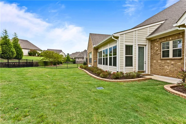 Well-maintained back yard with established flowers with miniature knockout roses