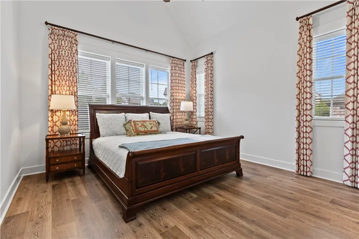 Back bedroom on the right side of the home. Vaulted ceiling and room for a king-sized bed. Custom drapes can convey with home or removed if desired.