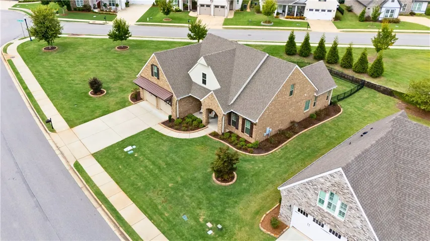 Large corner lot with a black aluminum fenced yard