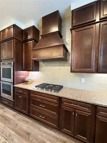 Gas cooktop with pot drawers below, double ovens