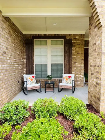 Beautiful covered porch perfect for enjoying the outdoors while reading, having coffee, and seeing your neighbors. It's so quiet you might fall asleep!
