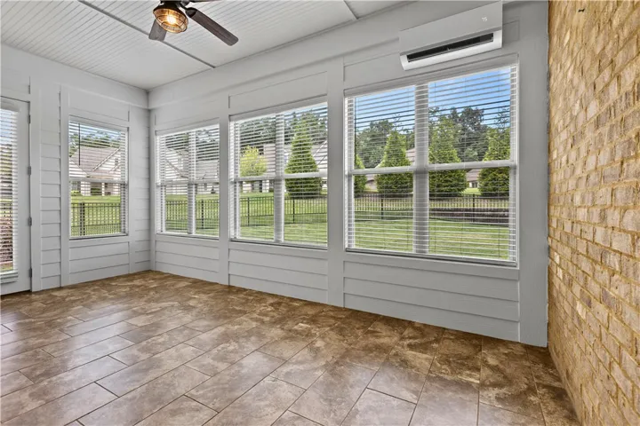 Spacious sunroom offers a lot of light! With open windows enjoy a sunroom room or with a a/c unit for more indoor living area. There is plenty of space for a dining area as well.
