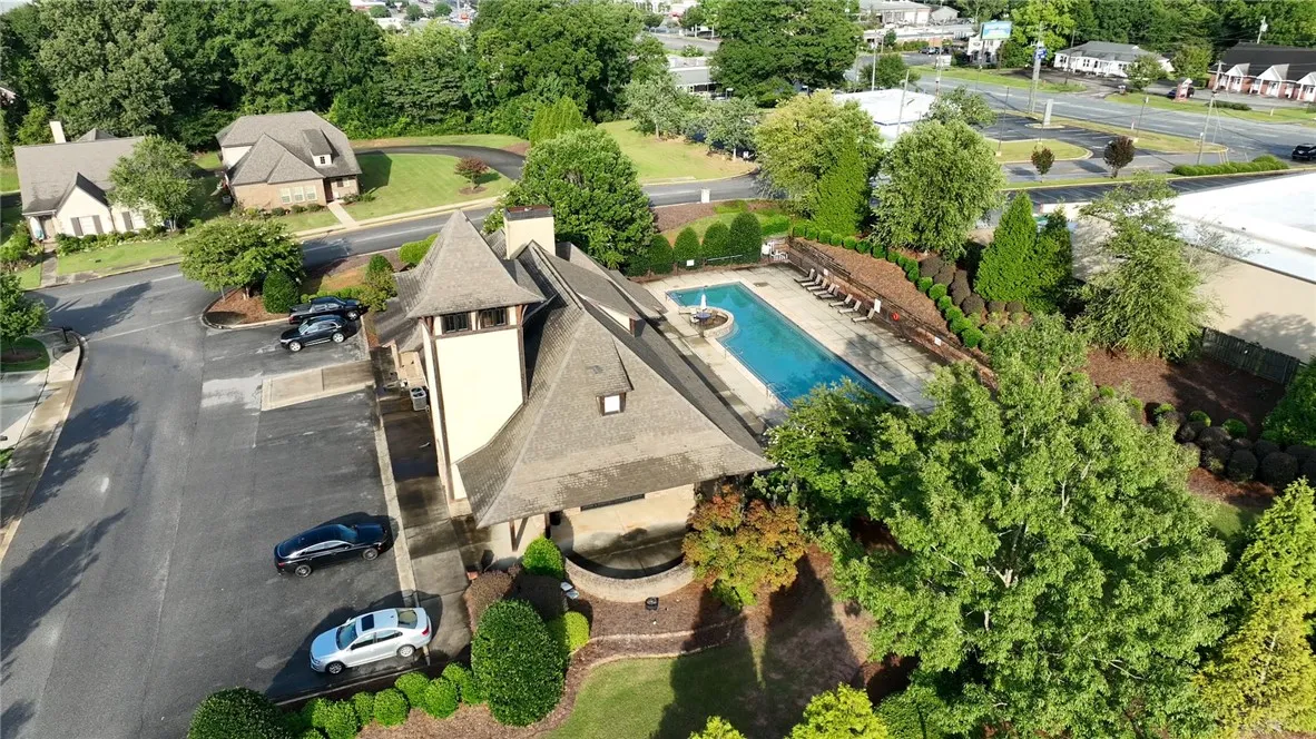 An aerial view showcases a swimming pool adjacent to the main building.