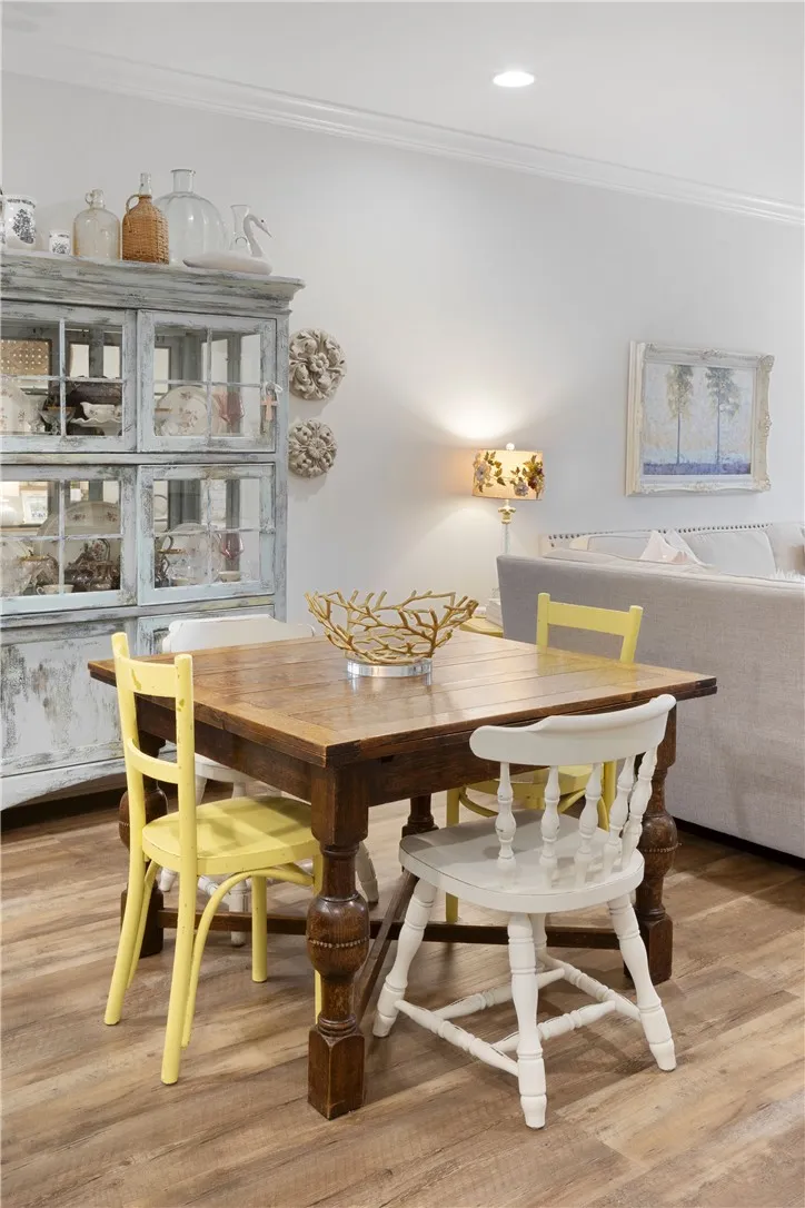 An inviting open layout connects the dining and living spaces over durable wood look flooring.