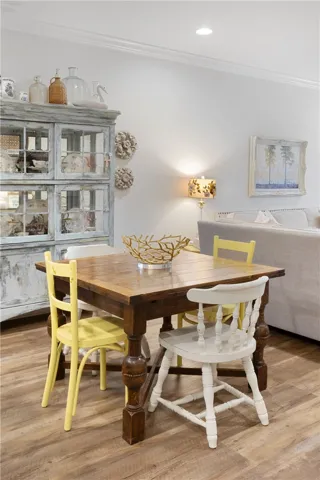 An inviting open layout connects the dining and living spaces over durable wood look flooring.