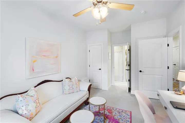 Crisp white walls and soft carpet anchor this versatile home office,  den space or bedroom.
