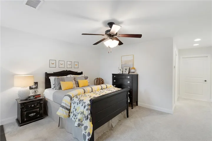 Soft carpeting pairs with smooth neutral walls in this comfortable and relaxing bedroom space.