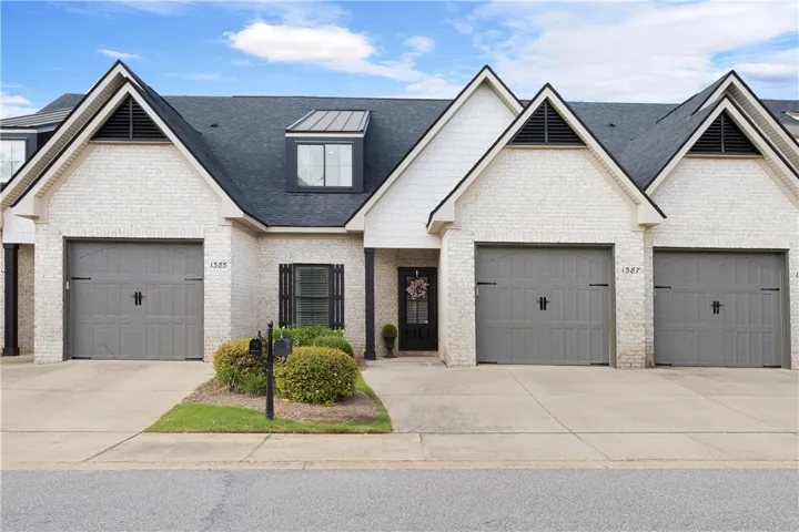 Striking brick accents and steep gables create an appealing facade for this lovely townhome.
