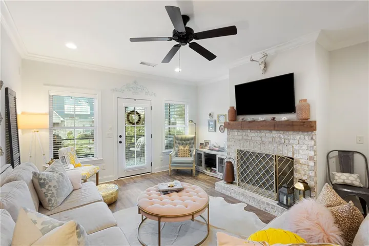 Wood look floors and a classic brick fireplace anchor this inviting living space.