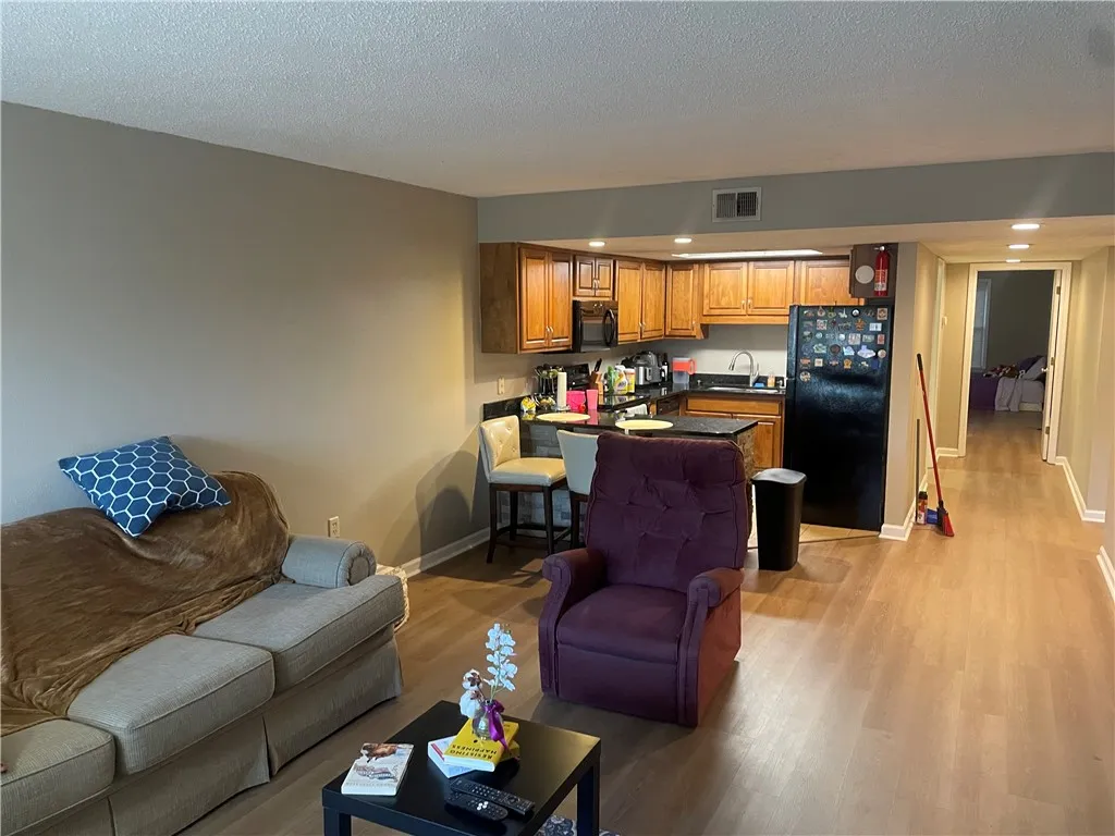 An open-concept layout unites the kitchen and living space, offering streamlined living.