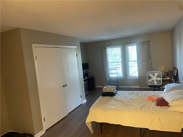 Well-lit bedroom features ample natural light and durable flooring for comfortable living.