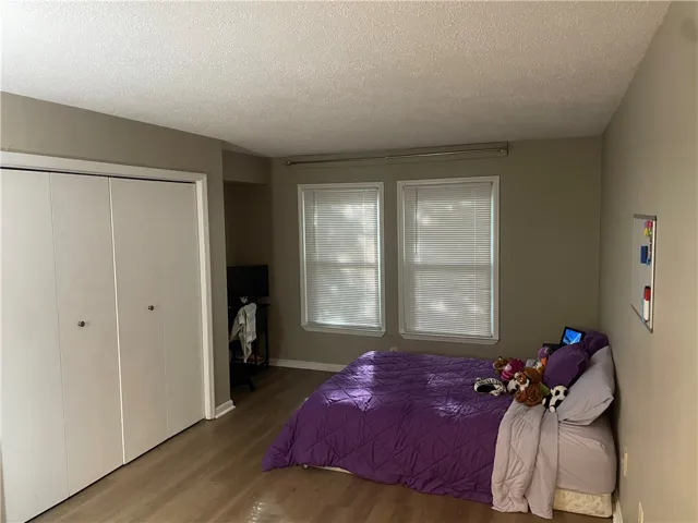 A comfortable sleeping area offers ample storage and abundant natural light.