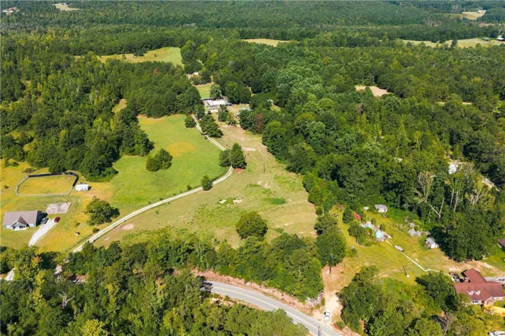 Discover vast acreage with verdant landscapes and private access roads, perfect for a secluded estate.
