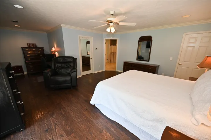 Primary bedroom with sitting area, walk-in closet, en suite bath, & attached flex room - perfect as an office, home gym, or dressing room!