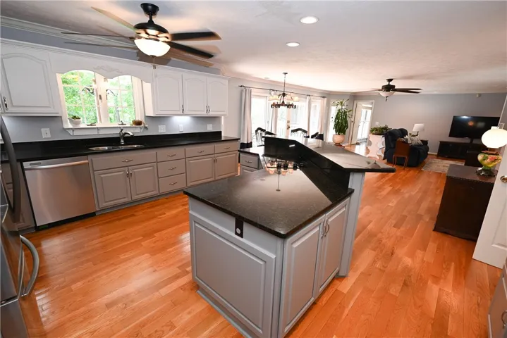 Center island with cook top, storage, & raised bar.
