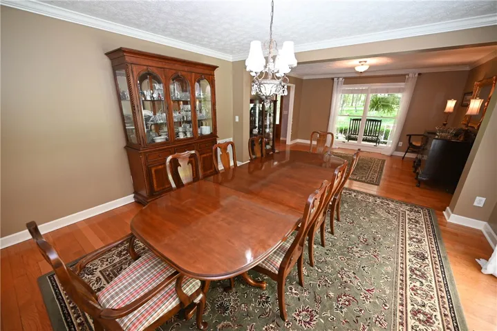 Formal dining with formal living room in background.