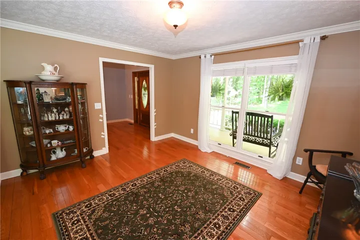 Formal living room with foyer in background
