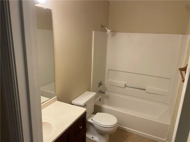 Functional layout features a neutral vanity and a combined tub and shower unit.