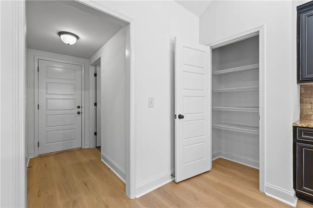 View of pantry and path to another pantry/storage closet, laundry room, and garage