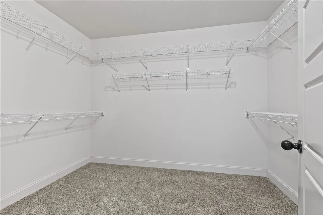 A well-organized walk-in closet featuring wire shelving for optimal storage and organization.