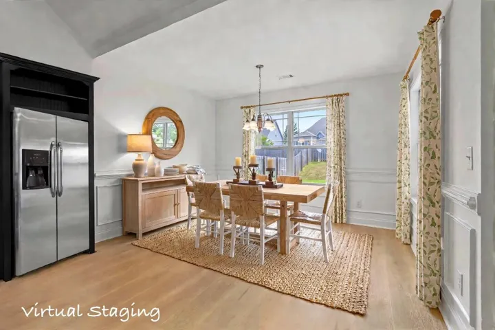 Virtually staged dining area, door on the rights leads to the covered porch