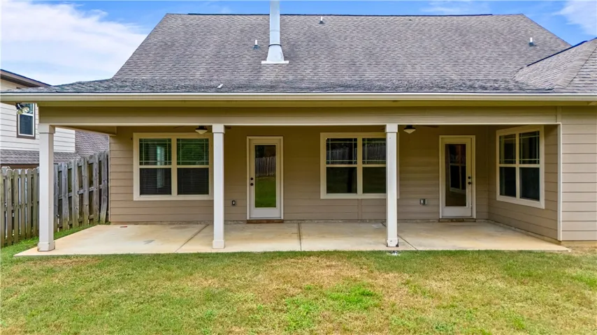 Covered patio offers a lot of space for outdoor furniture, plants, grilling area, etc.