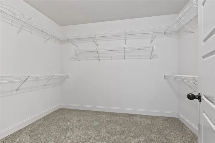 A well-organized walk-in closet featuring wire shelving for optimal storage and organization.