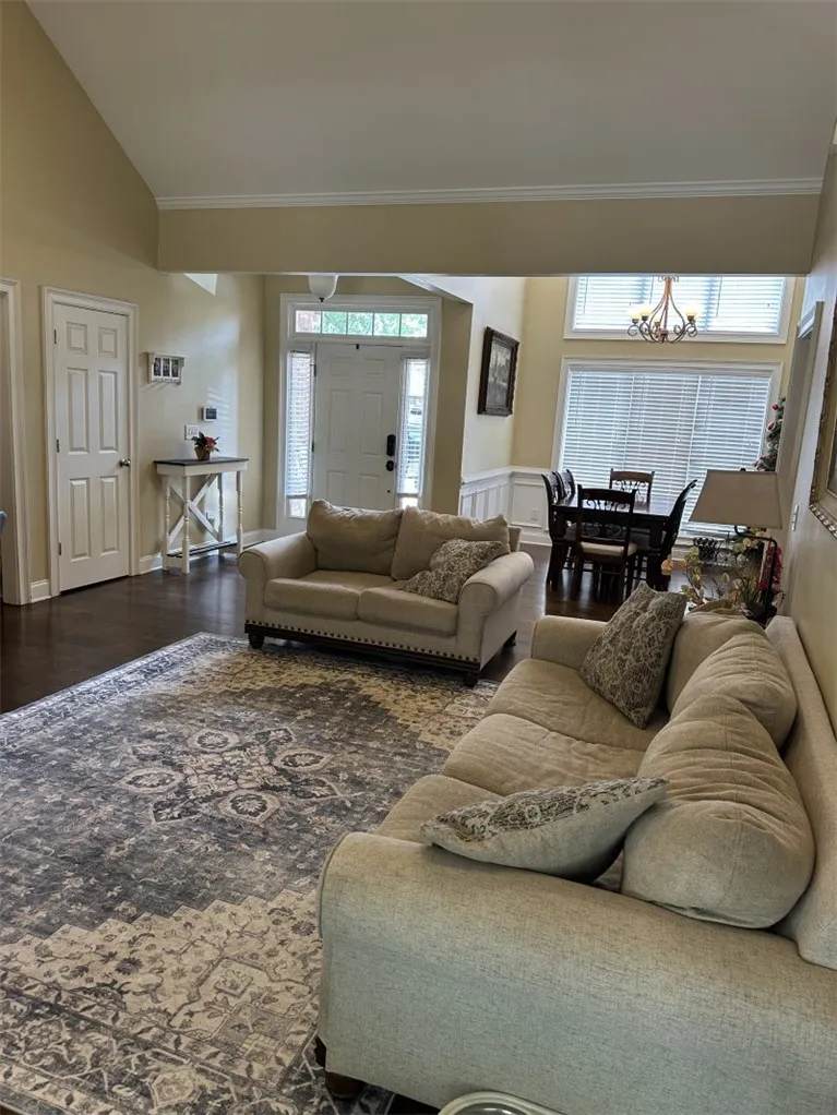 Gleaming hardwood floors and a vaulted ceiling elevate this open-concept main living space.