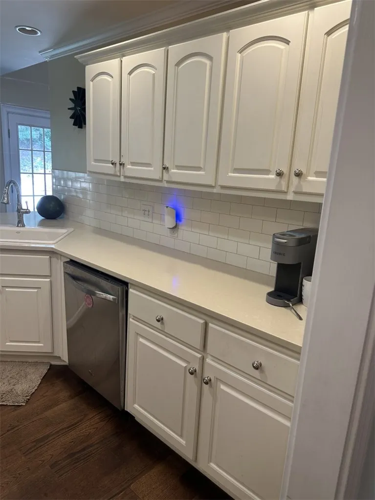 Gleaming stone countertops and classic cabinetry elevate this bright culinary space.