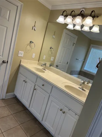A spacious double vanity with classic cabinetry serves as the focal point in this bathroom.
