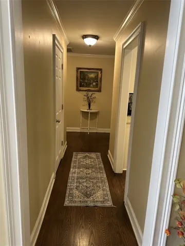 Gleaming hardwood floors and classic crown molding line this welcoming hallway corridor.