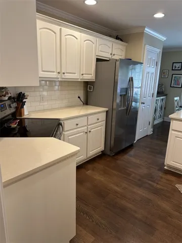 Gleaming hardwood floors and classic cabinetry anchor this well-appointed kitchen workspace.