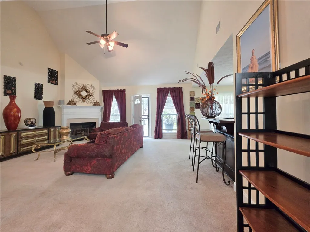 Vaulted ceilings and a wood-burning fireplace anchors this expansive, open living area.