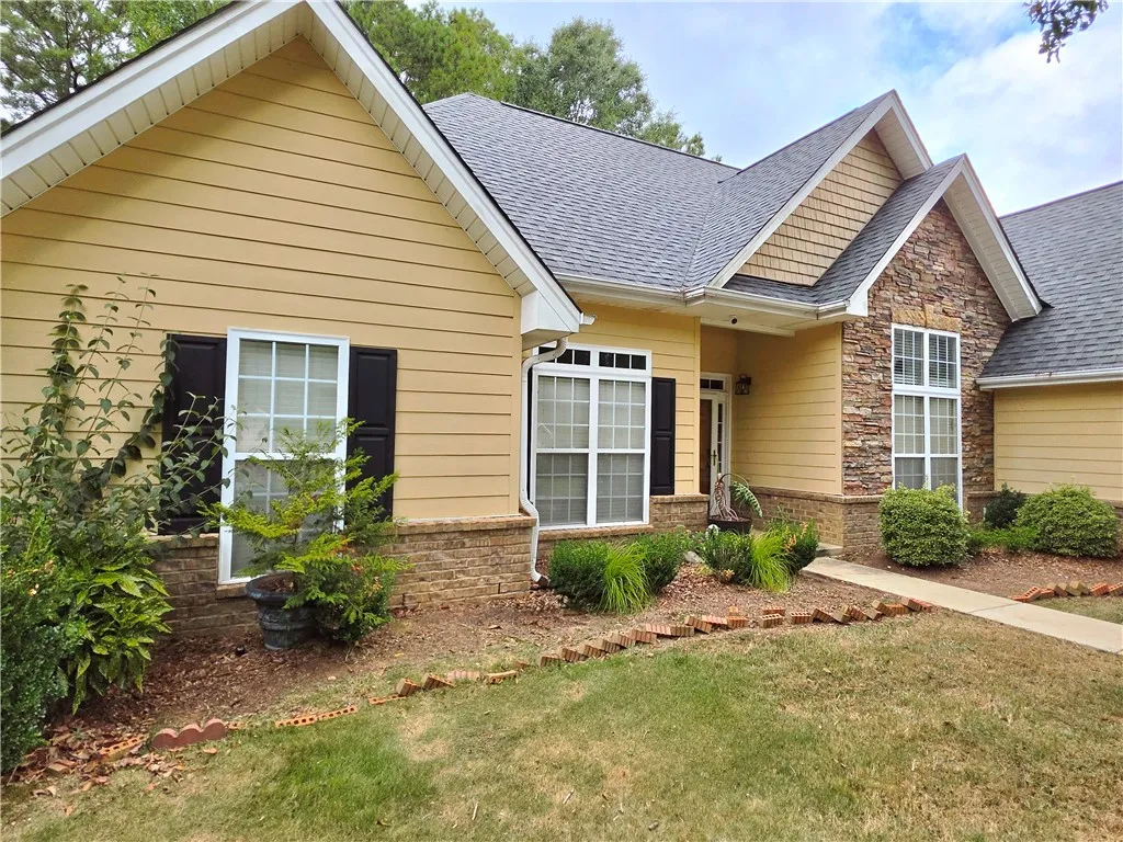 A mix of siding, stone veneer, and classic gables defines this exterior facade.