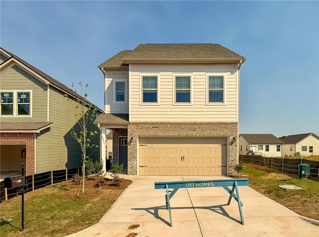 A classic facade features a brick lower level and neat siding under a shingled roof.